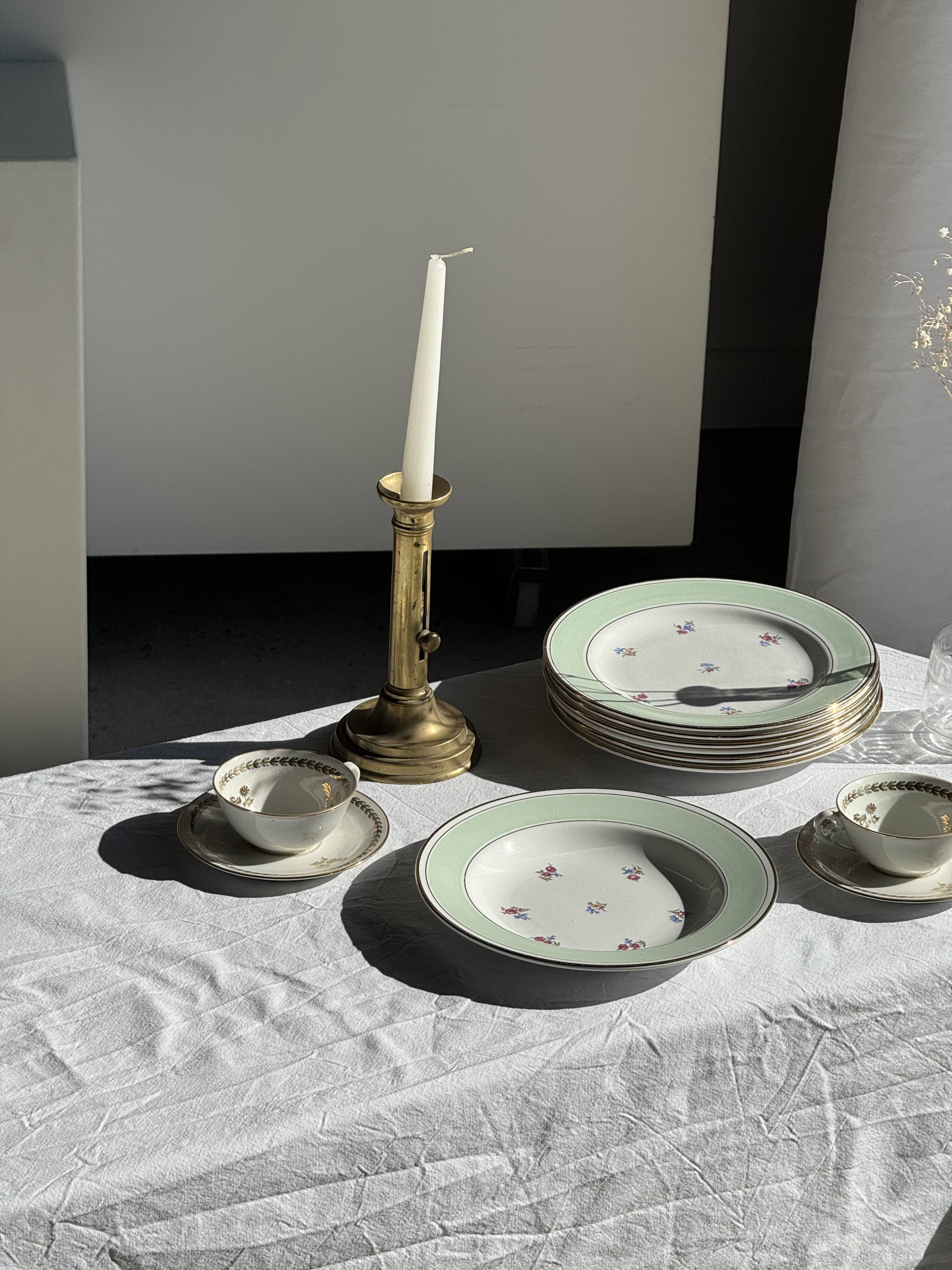 Set of 9 vintage turquoise deep plates with gold trim and pink flowers.