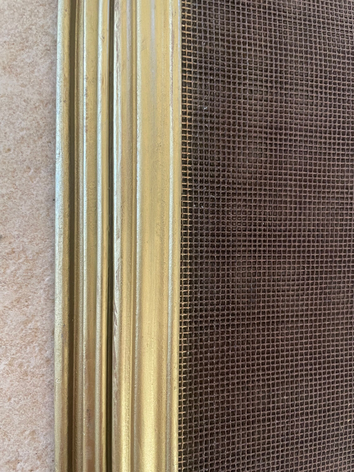 Five-panel golden metal fireplace screen from the 19th century.