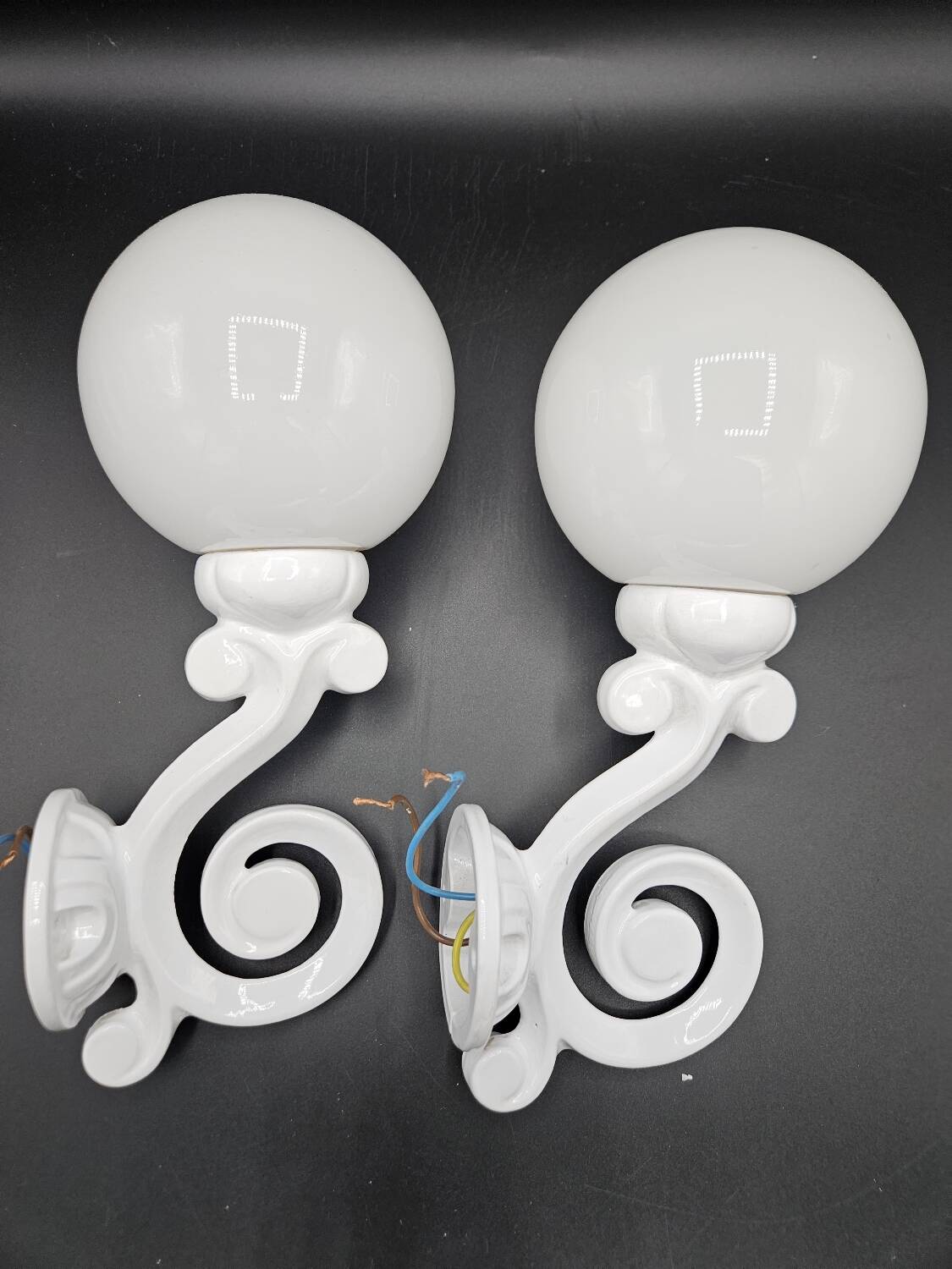 Pair of white enameled cast iron wall sconces, mid-20th century