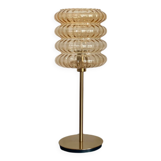 Table lamp with an old vintage golden streaked globe and a golden foot