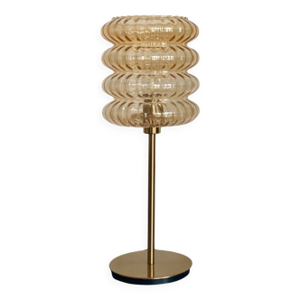 Table lamp with an old vintage golden striped globe and a golden foot