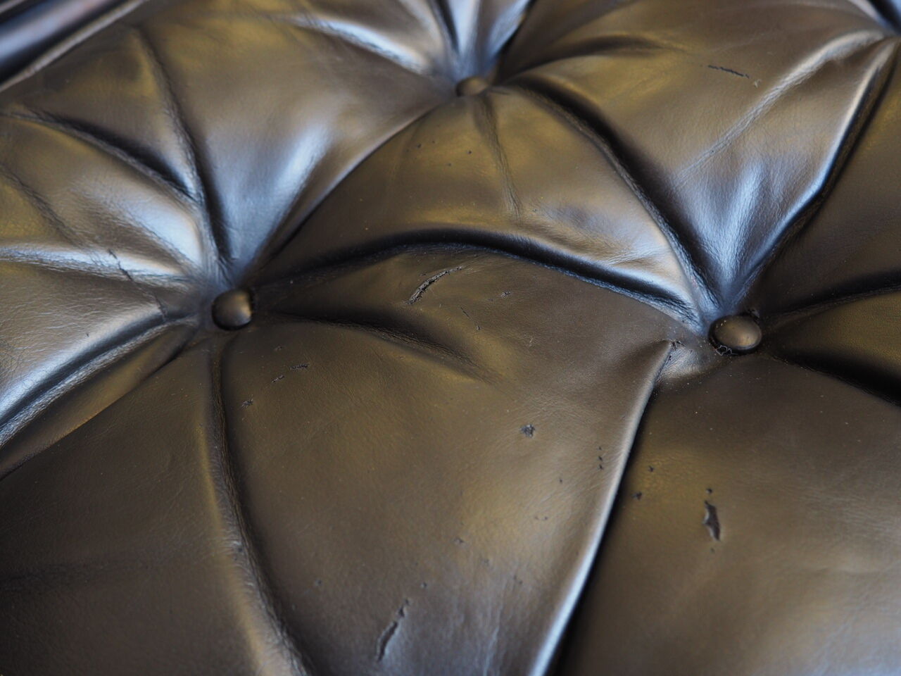 Chesterfield style leather armchair & footstool by Hancock & Moore