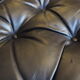 Chesterfield style leather armchair & footstool by Hancock & Moore