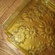 Pressed glass yellow bowl with floral pattern by Portieux.