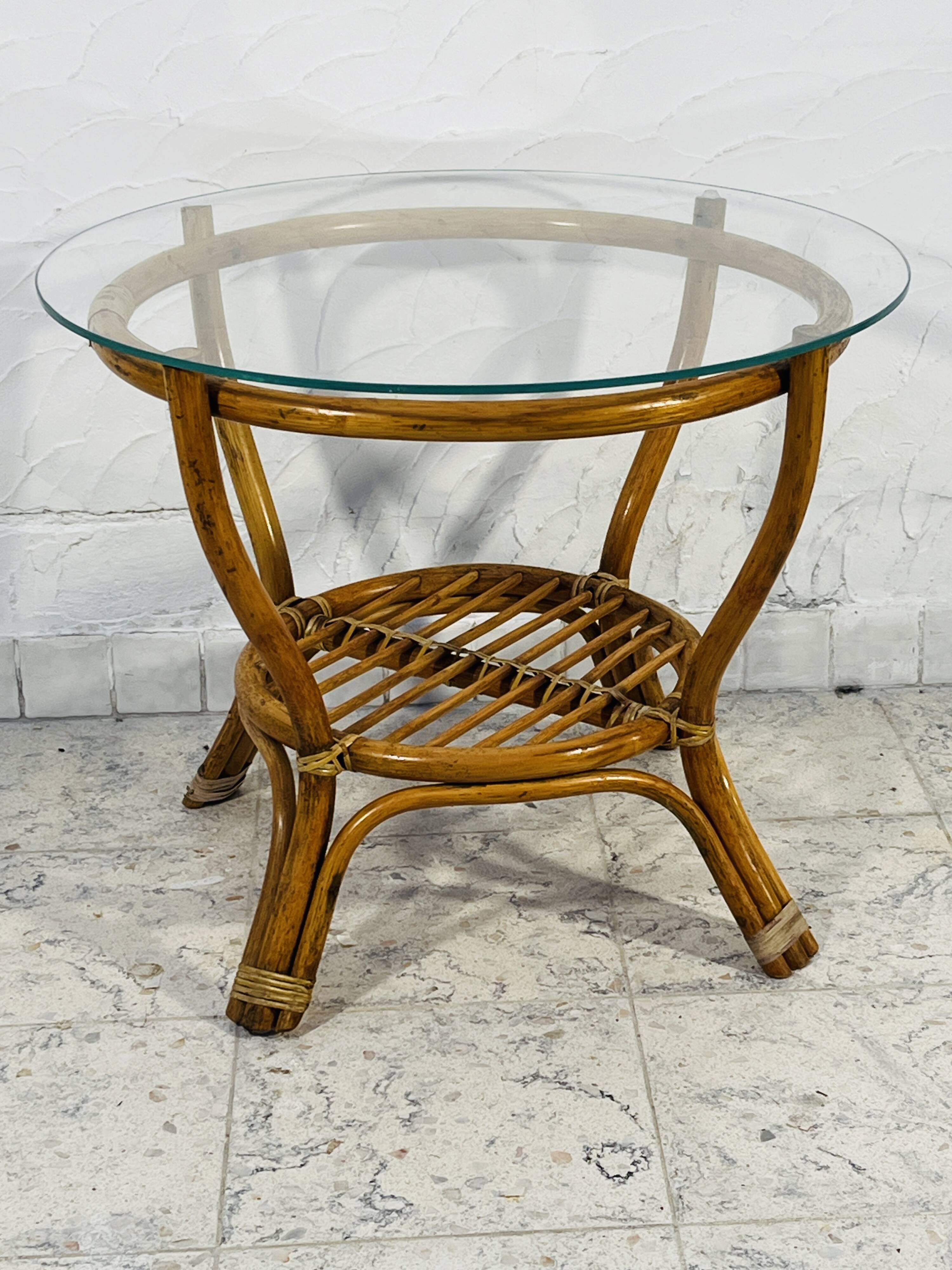 Vintage rattan coffee table with glass top from the 1970s.