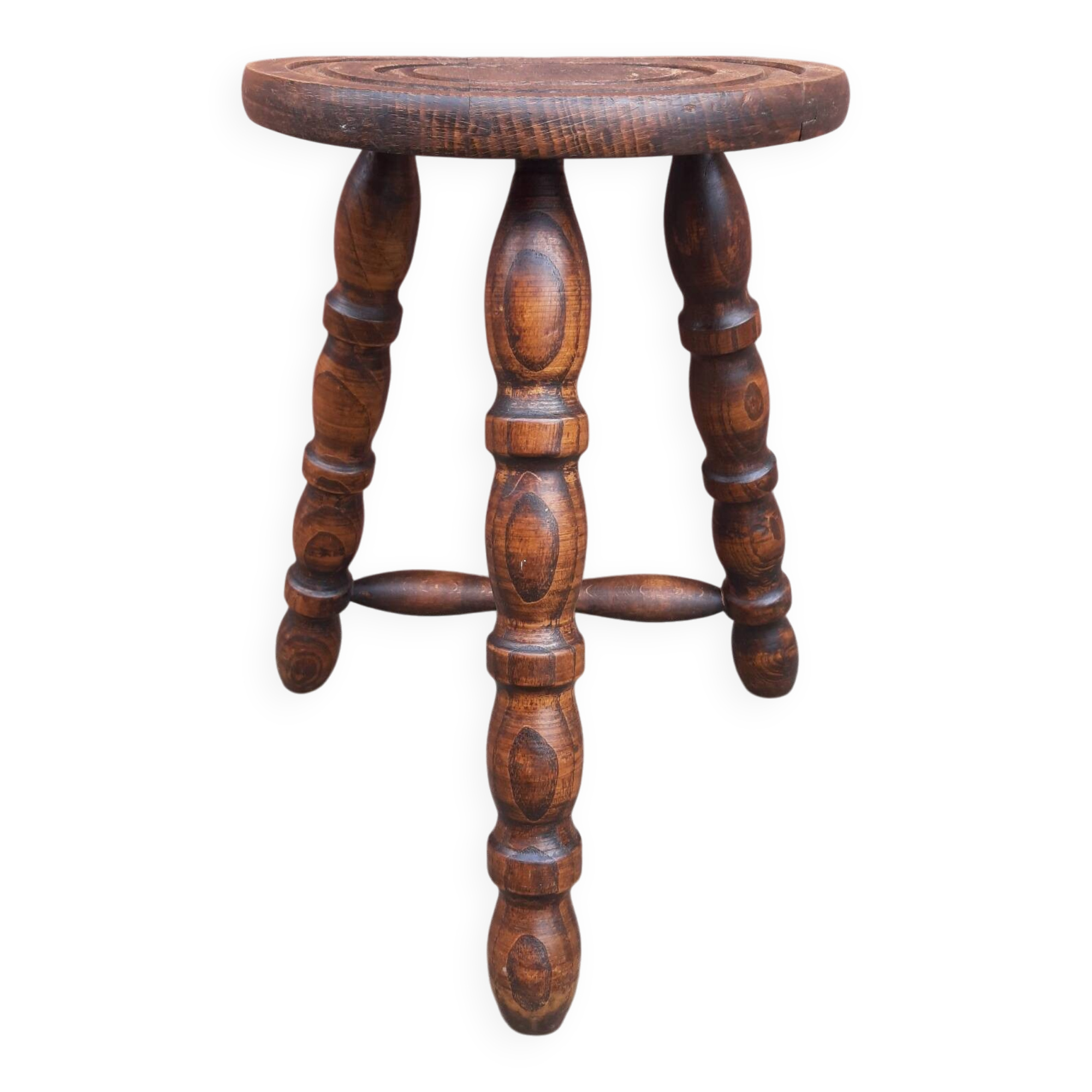 Low wooden tripod stool.