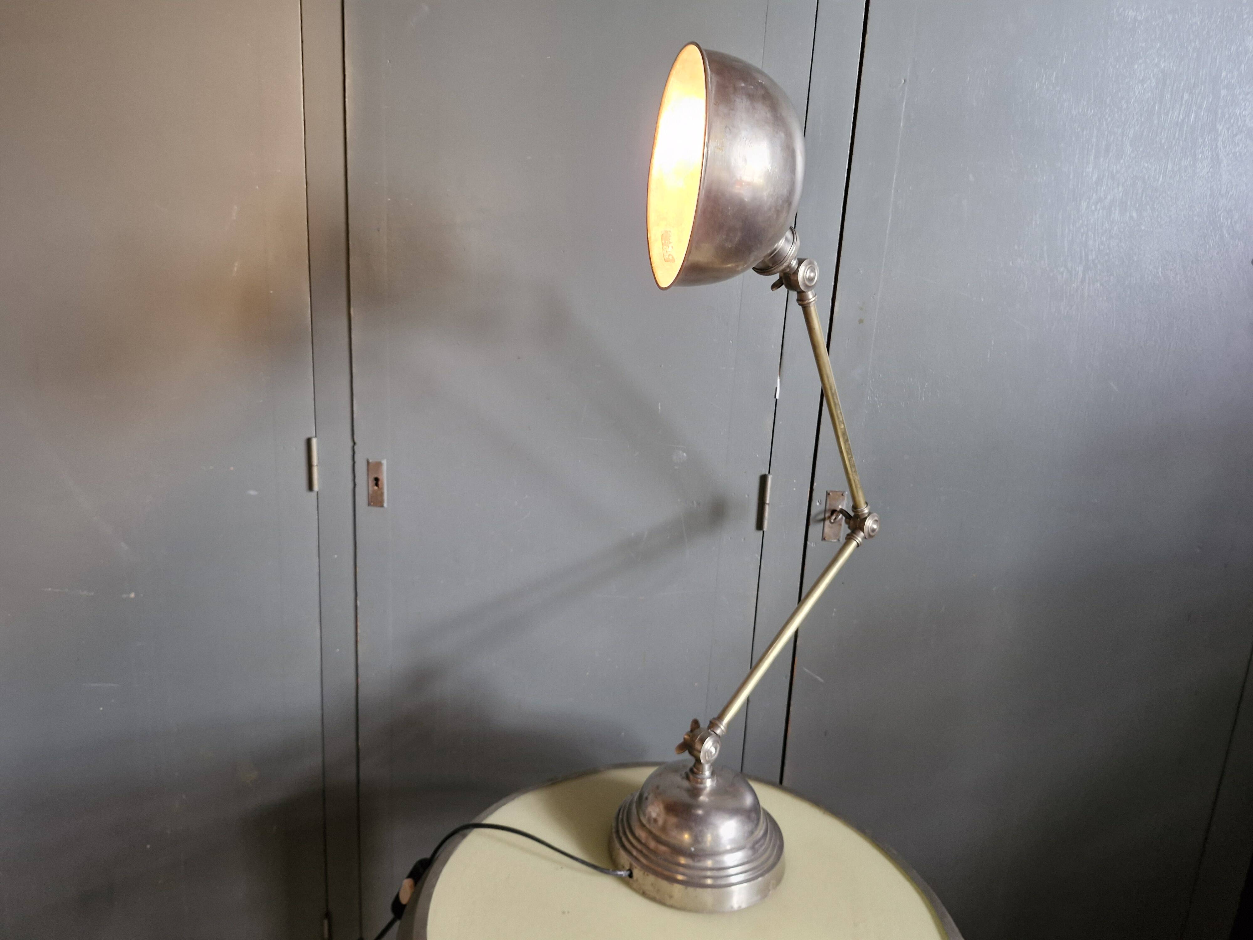 Old adjustable industrial lamp in bronze with 2 arms.