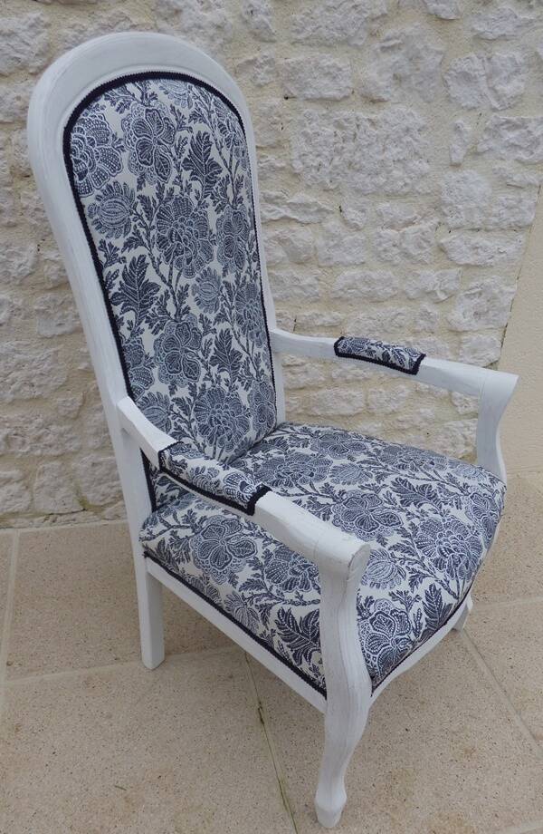 Voltaire style armchair covered in floral fabric in quality aged wood