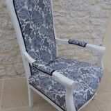 Voltaire style armchair covered in floral fabric in quality aged wood