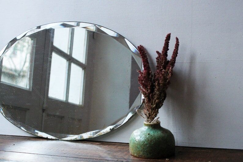 Old oval beveled art deco mirror