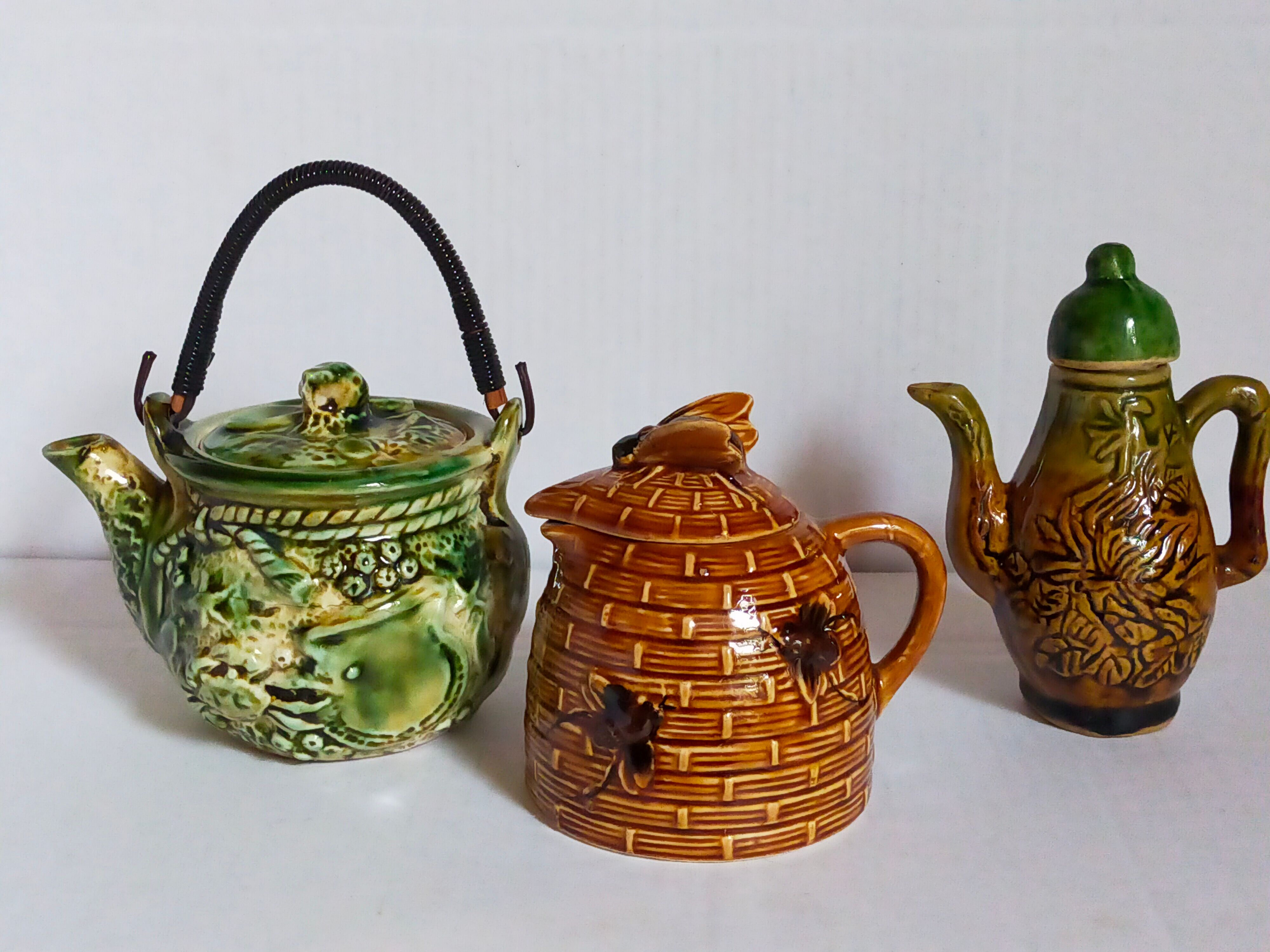 Set of old teapots and honey pot