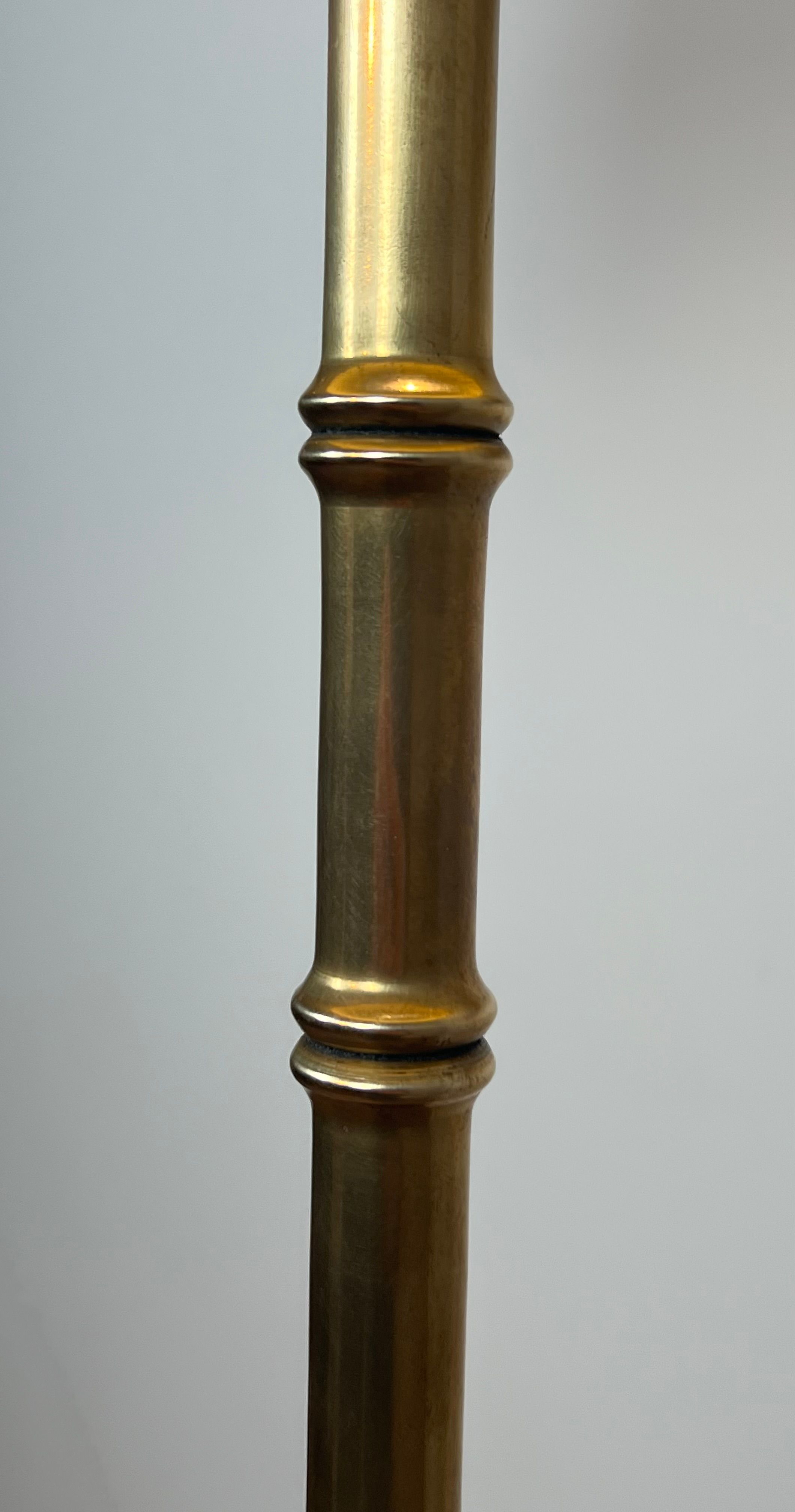 Pair of parquet floor lamps in faux-bamboo style in bronze and brass by Jacques Adnet.