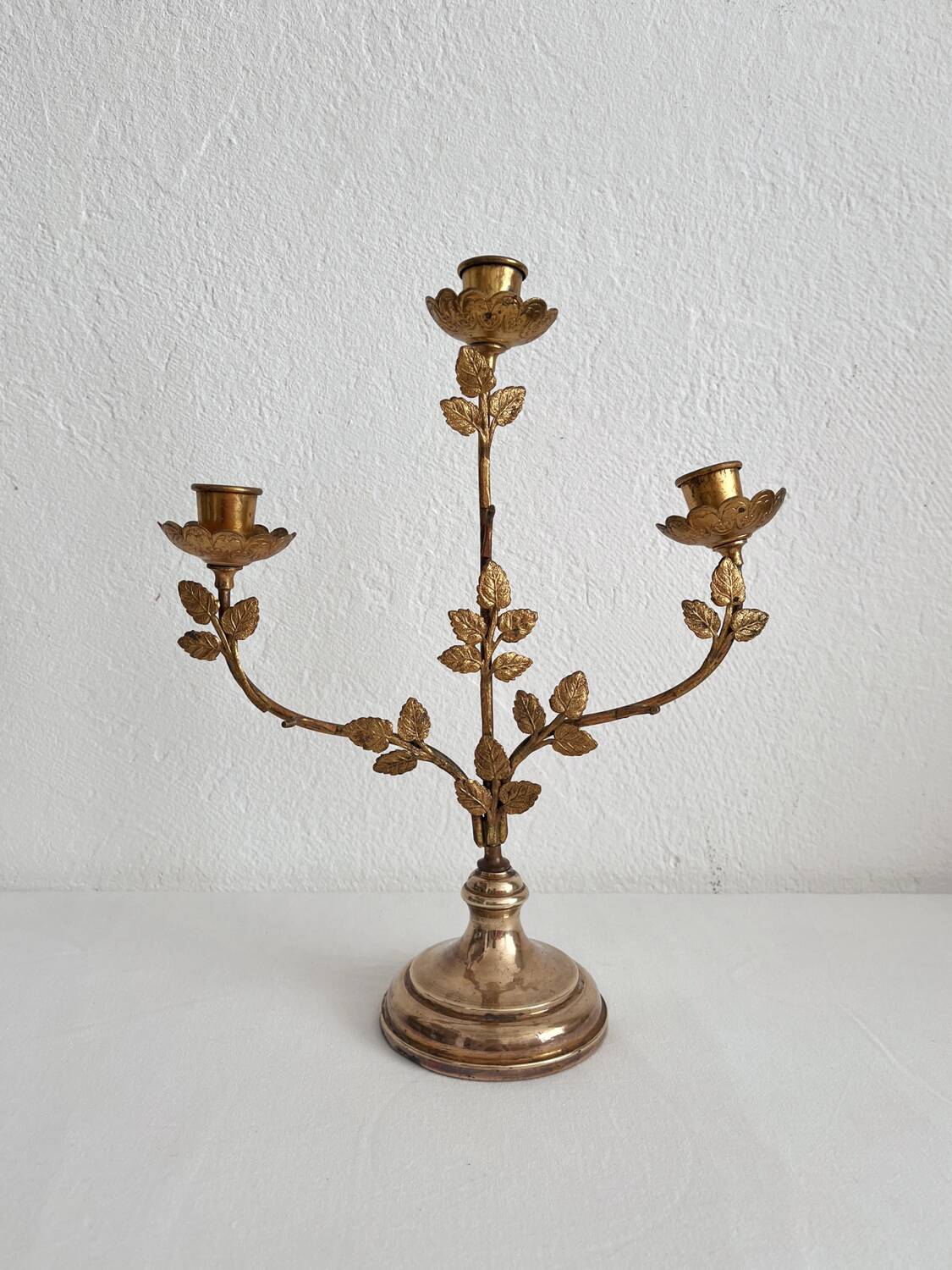 Antique bronze and brass candlestick with golden leaves