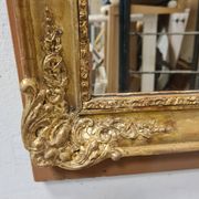 Antique gilded mirror, 19th century Empire style.