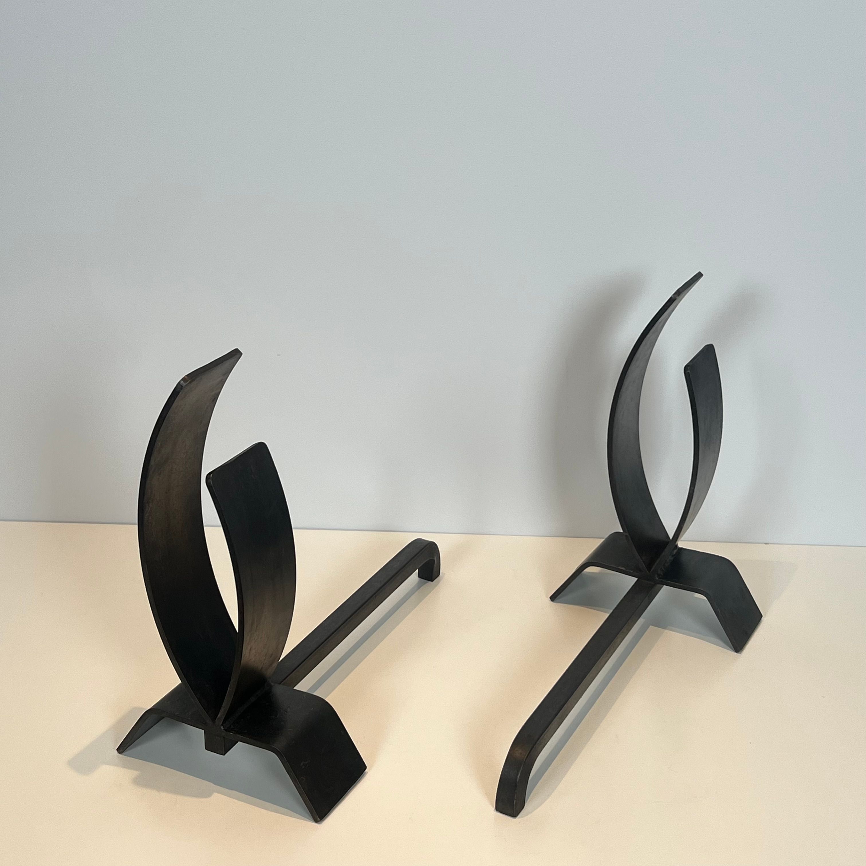 Pair of modernist andirons in steel and wrought iron