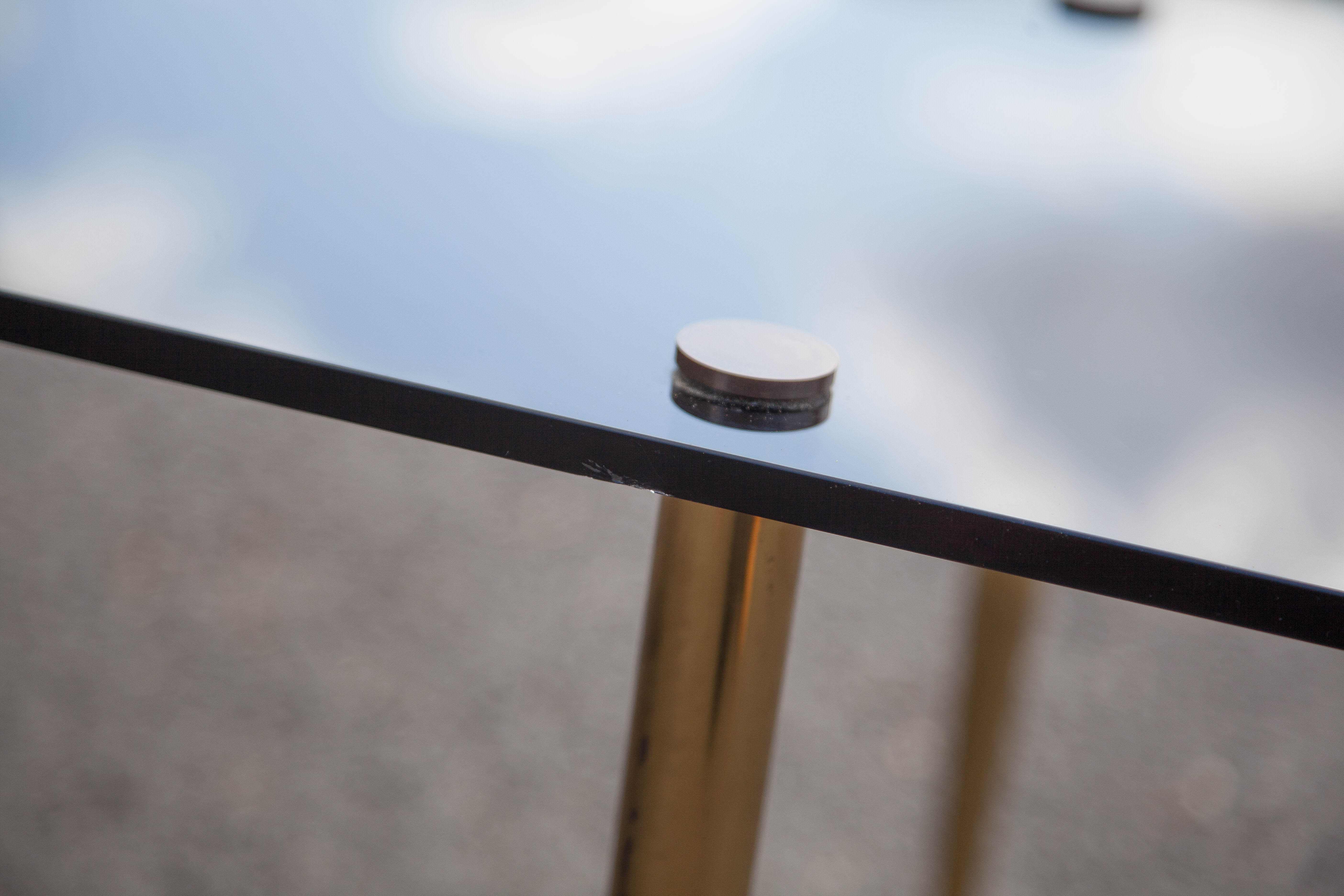 Smoked glass coffee table with adjustable brass legs, end of sofa, 70s table