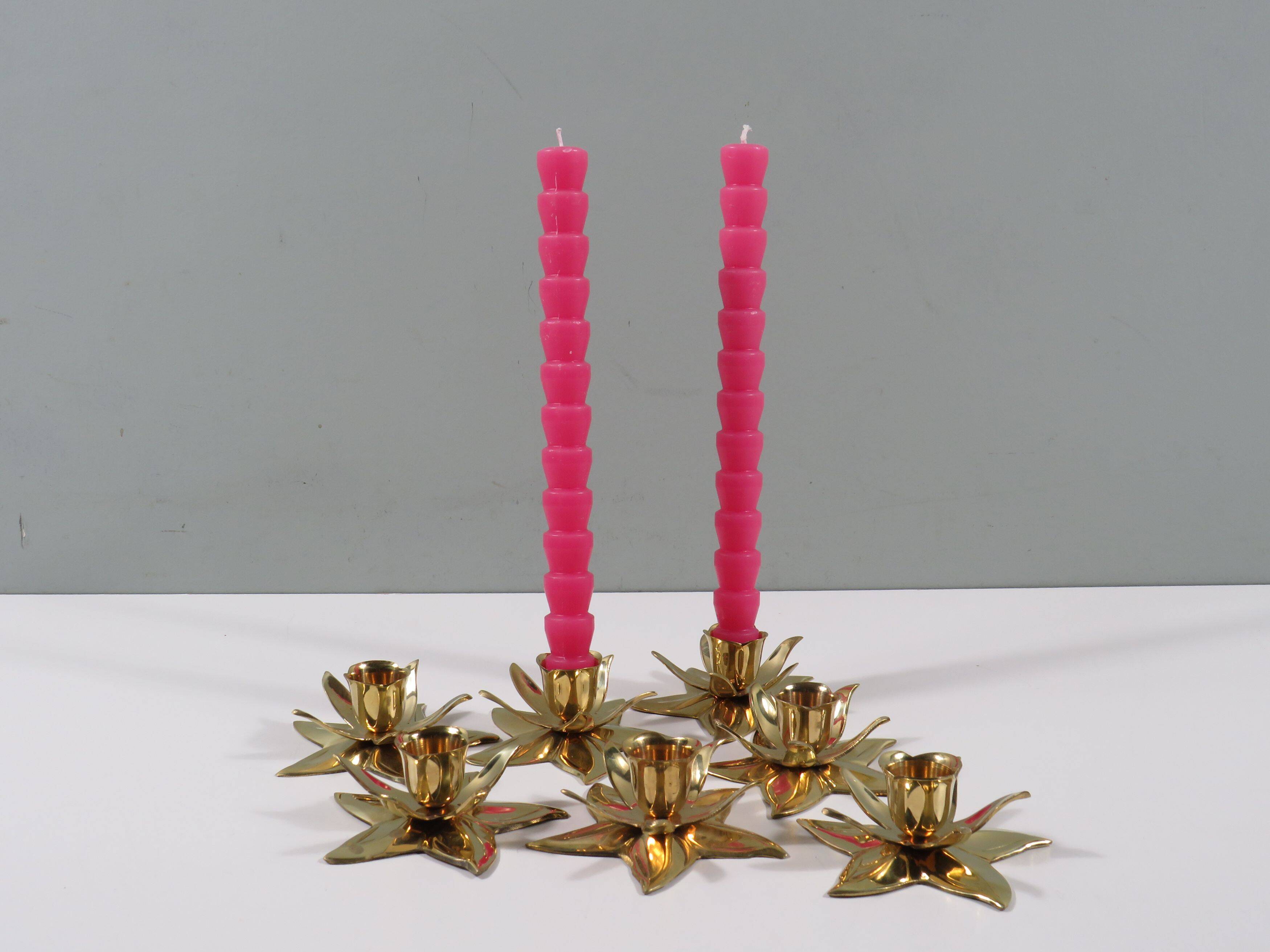 Set of 7 heavy shiny brass flower shaped candle holders, 1970-1980