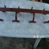 Coat rack with four double curved wooden pads