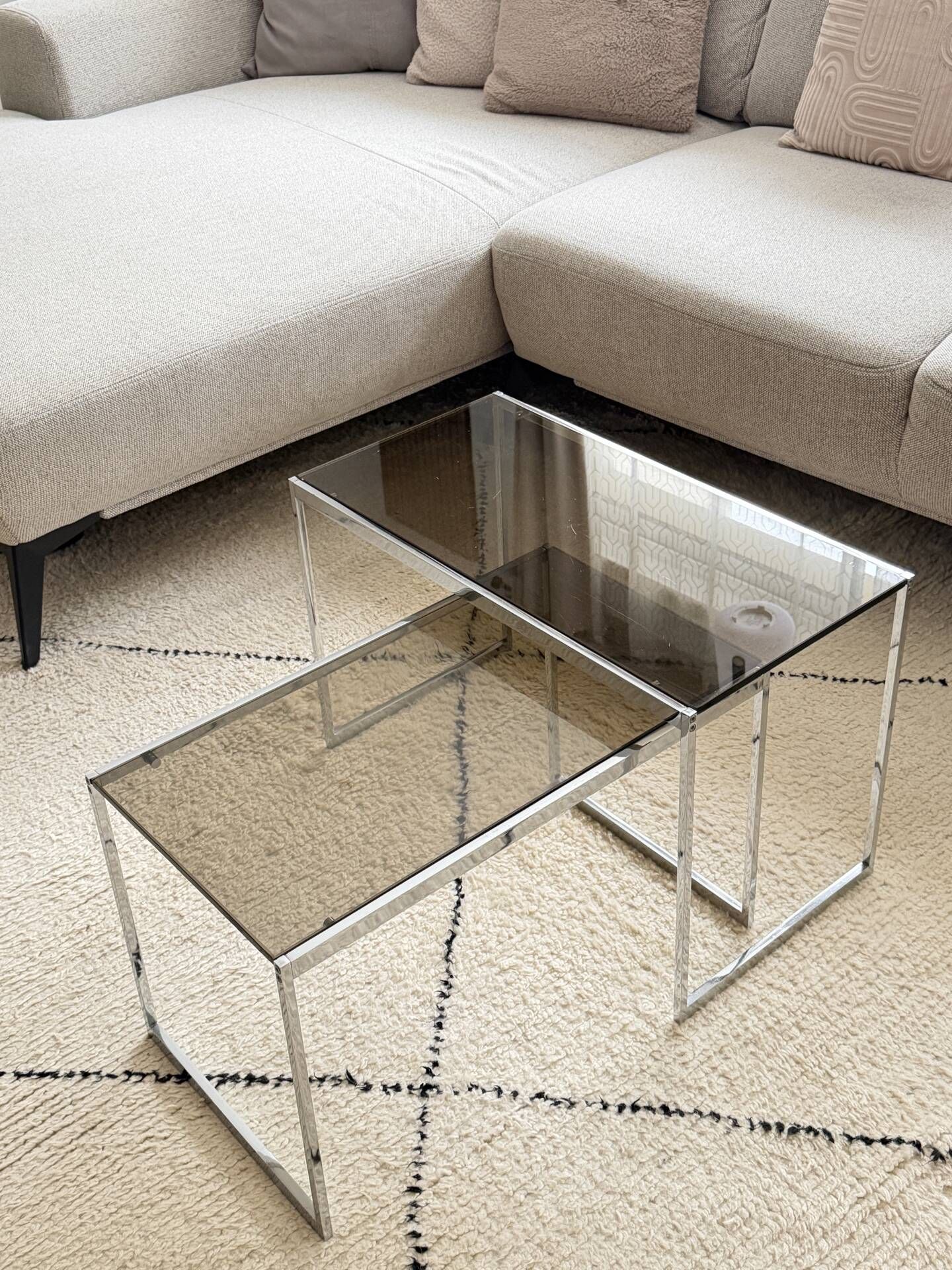 Set of 2 vintage nesting coffee tables in chrome metal and smoked glass.