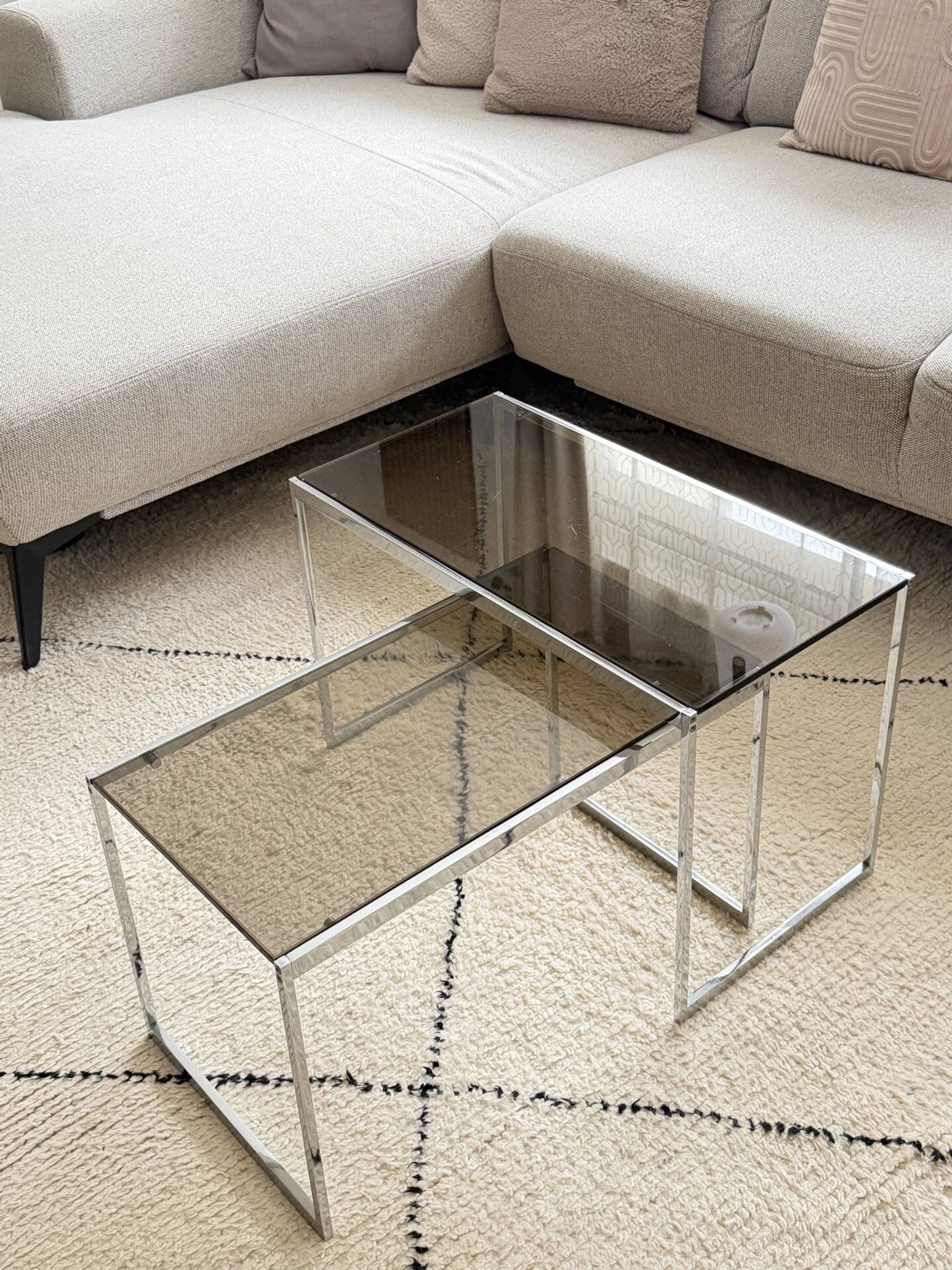 Set of 2 vintage nesting coffee tables in chrome metal and smoked glass.