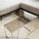 Set of 2 vintage nesting coffee tables in chrome metal and smoked glass.