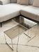 Set of 2 vintage nesting coffee tables in chrome metal and smoked glass.