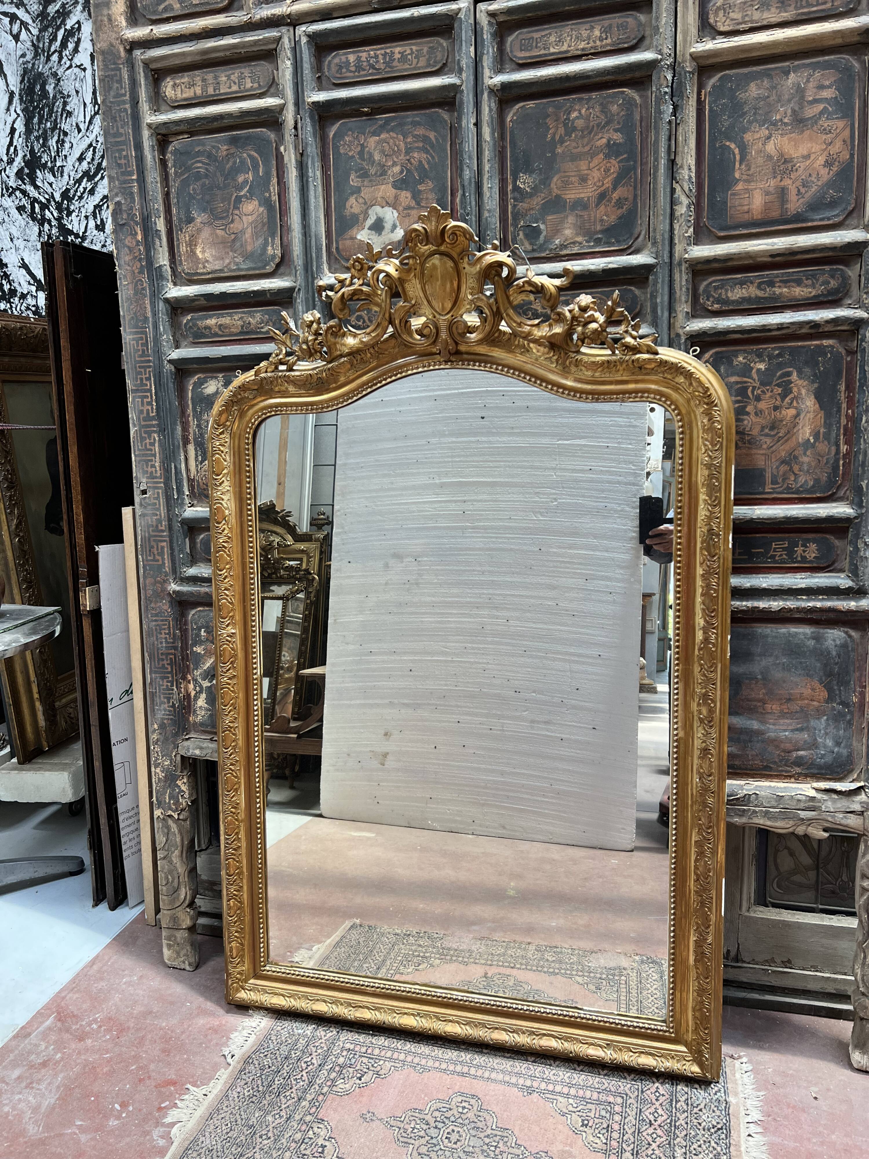 Louis XV style mirror in gilded wood and stucco, 20th century.