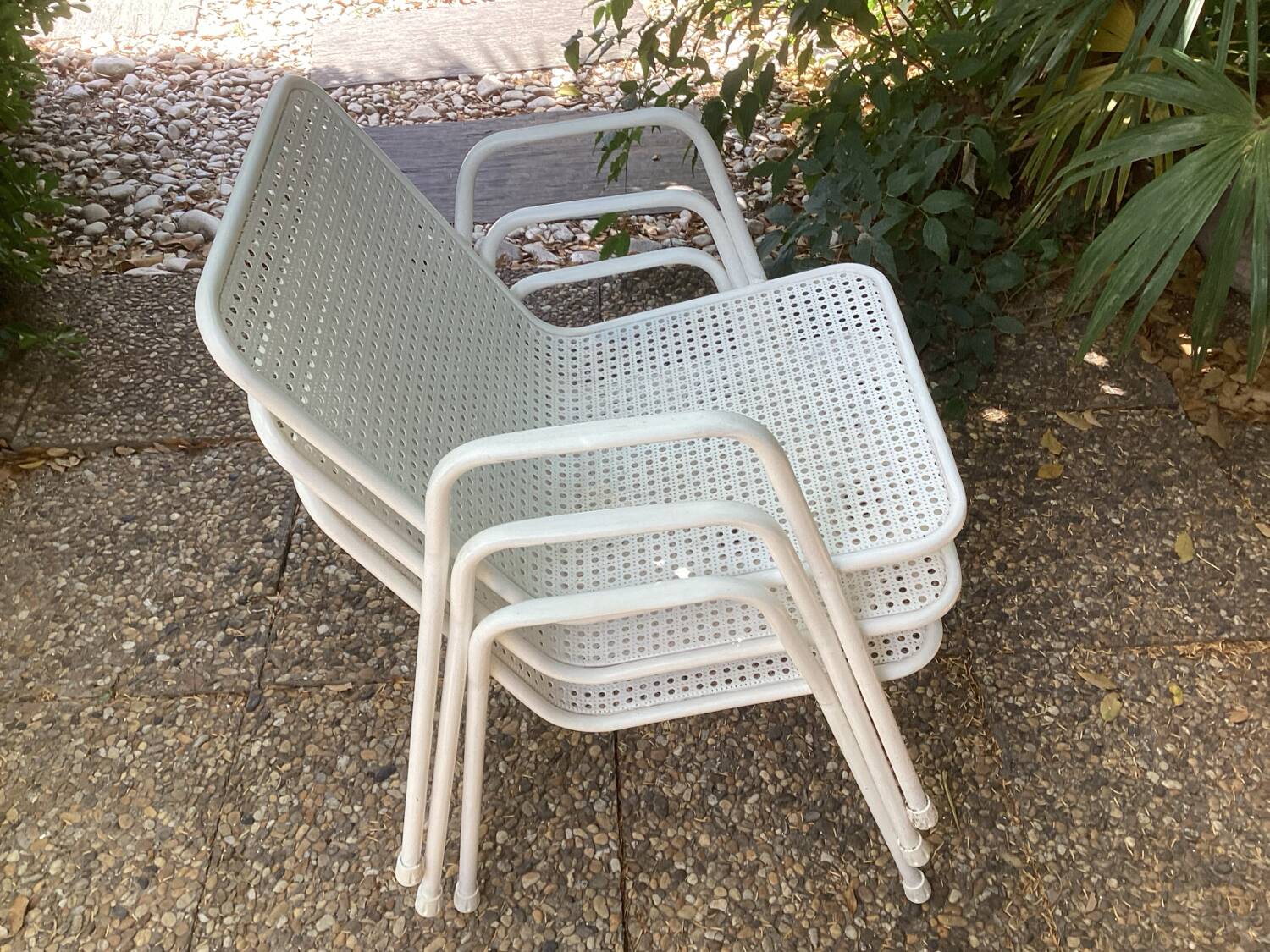 Perforated metal armchairs
