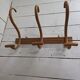 Curved wooden coat rack with 3 hooks, 1920s.