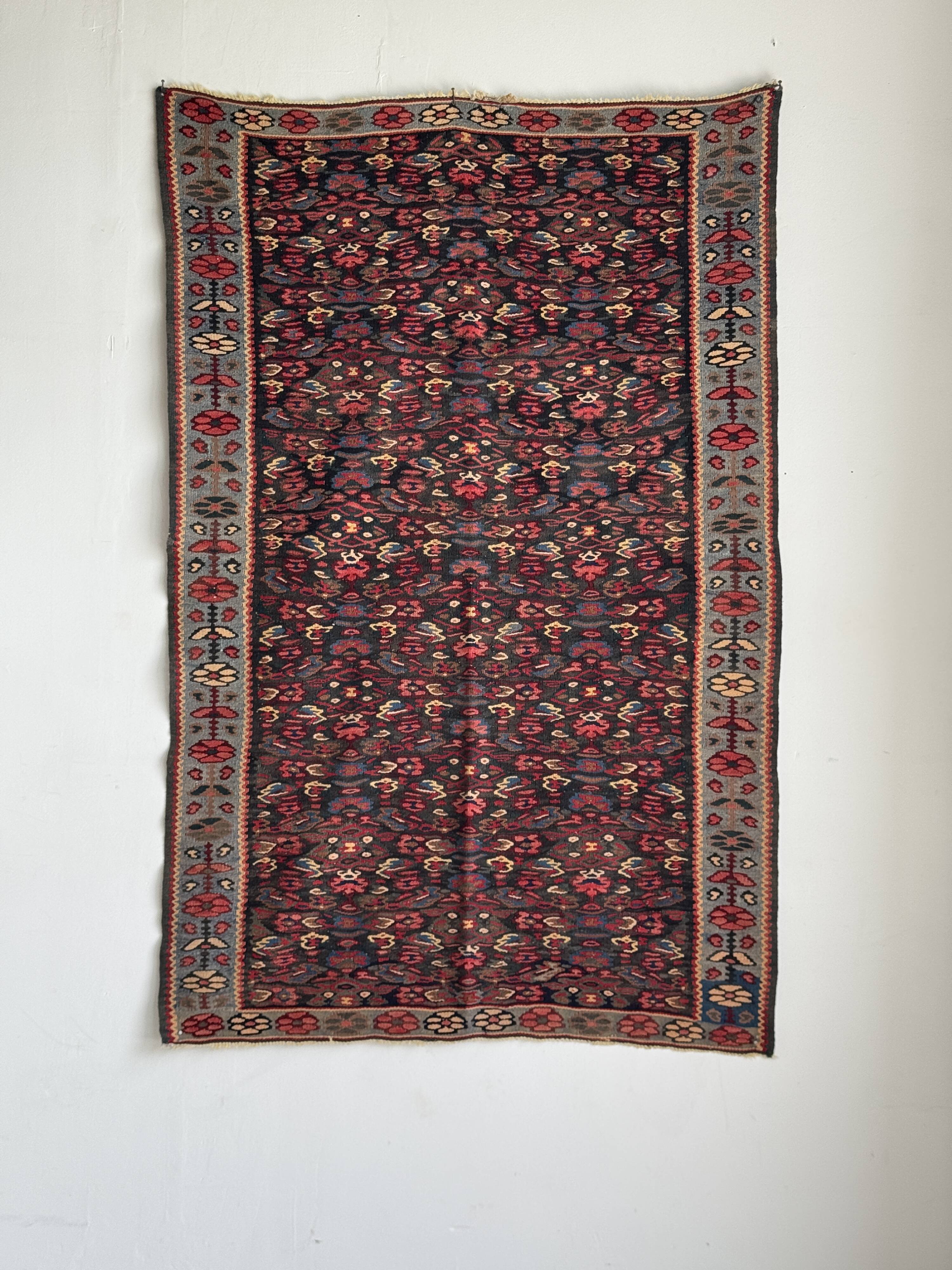 Iranian rug with stylised floral patterns in pink and blue, 155x105.