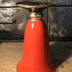 Cut vase on foot in red and black metal