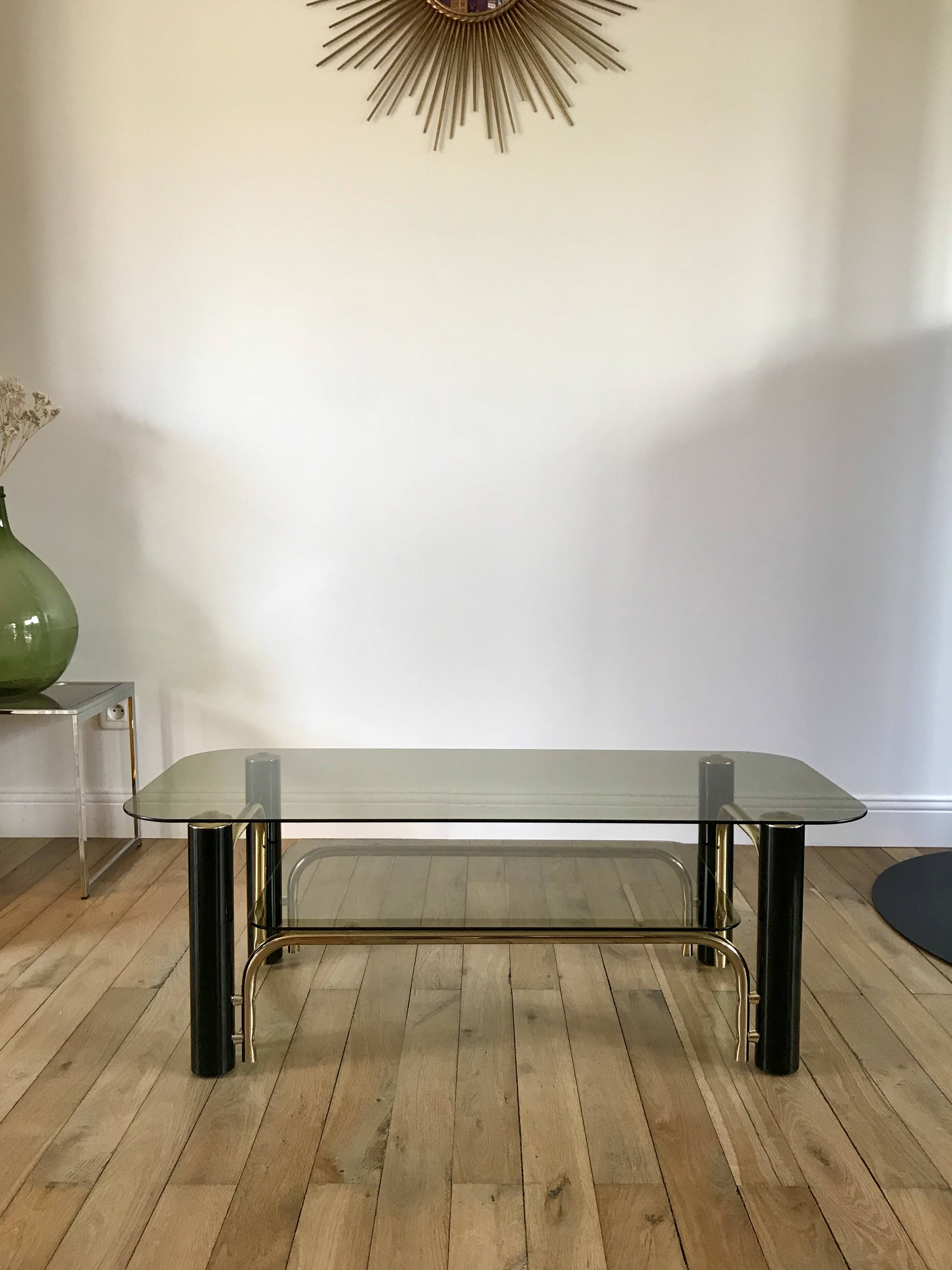 coffee table in smoked glass and black and gold metal from the 70s