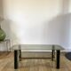 coffee table in smoked glass and black and gold metal from the 70s