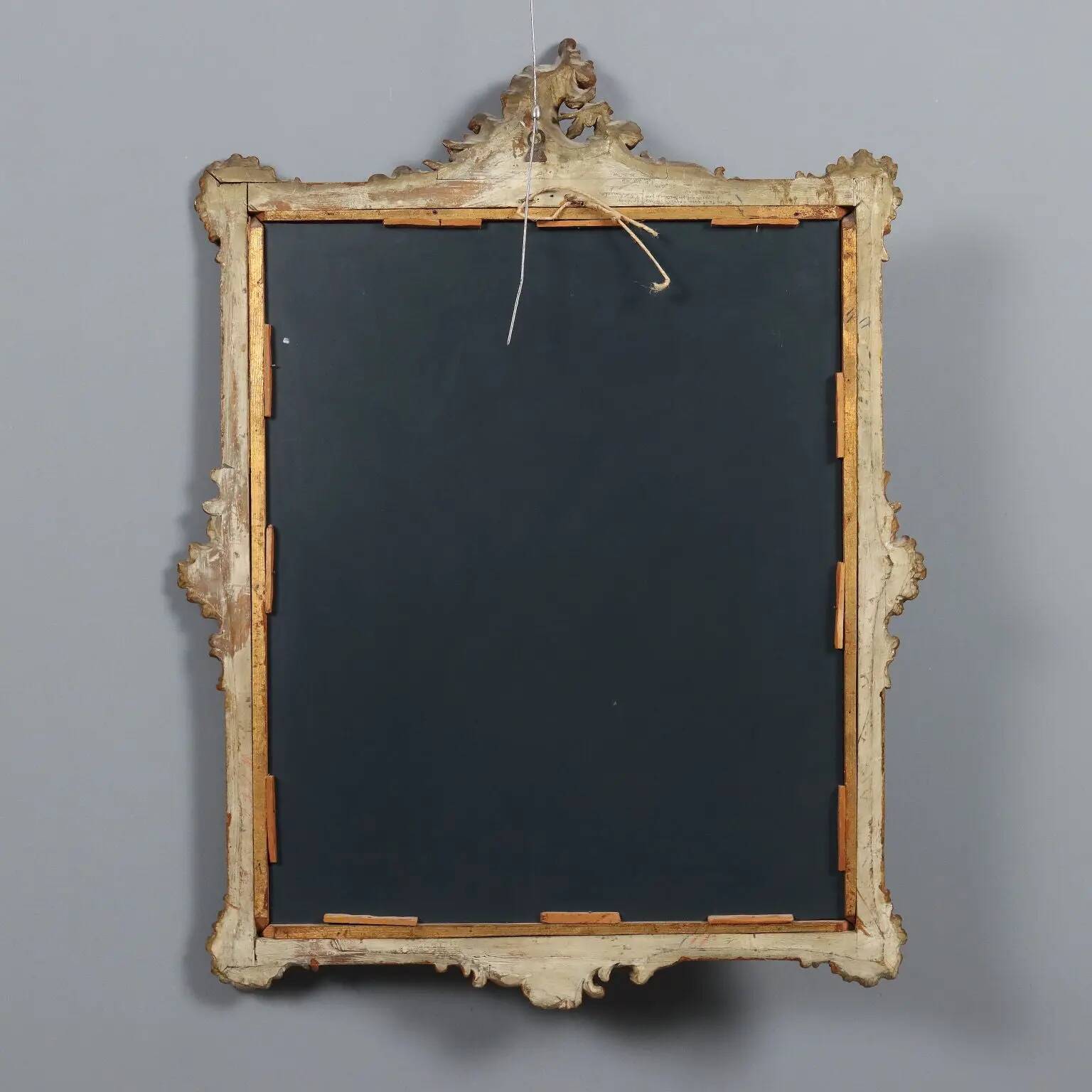Antique Rococo-style mirror in carved gilded wood, 20th century.