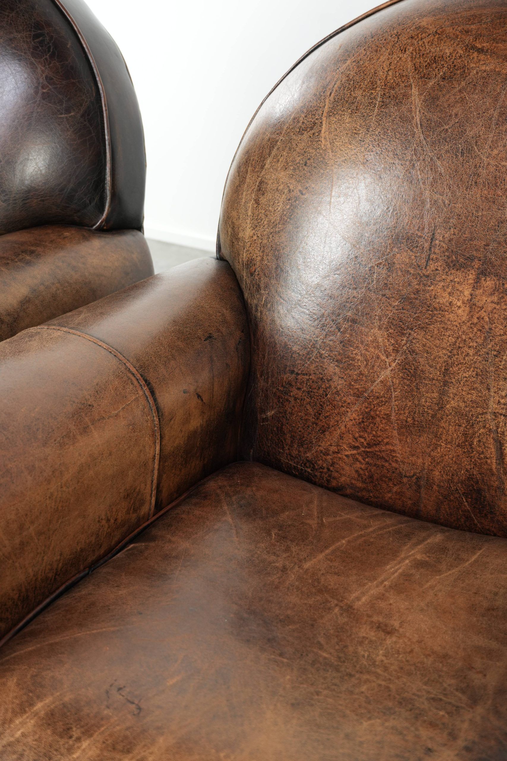 Set of two sheepskin Art Deco design armchairs with beautiful patina