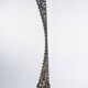 Indonesian construction element in carved wood with intertwined plant motifs mounted on a base (fri