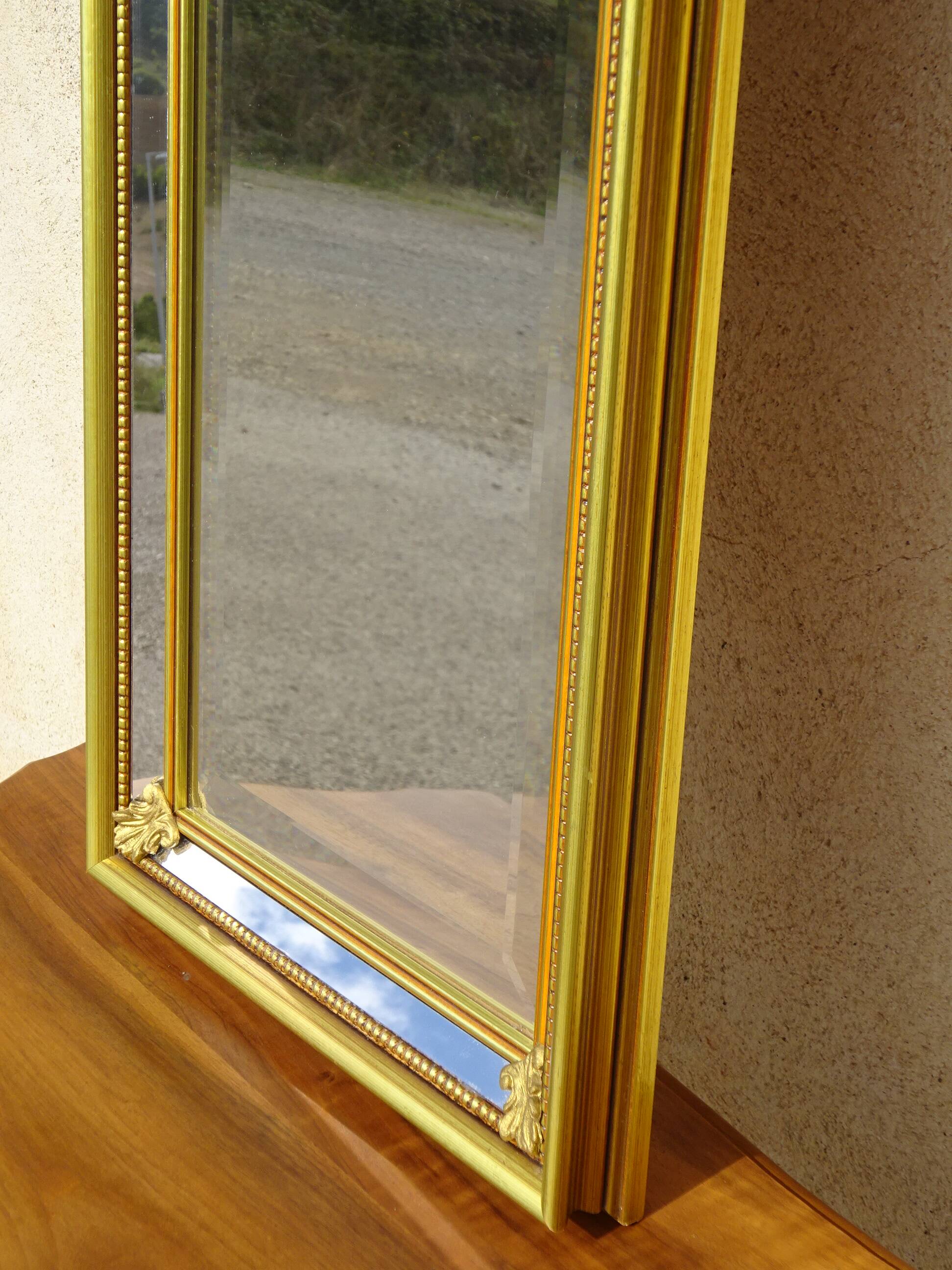 Vertical mirror, gold frame with beading.