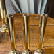Set of candlesticks and tubular vases in solid brass.