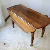 Mid-19th-century walnut round table with shutters, flaps