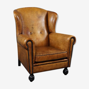 Antique armchair in patinated sheepskin