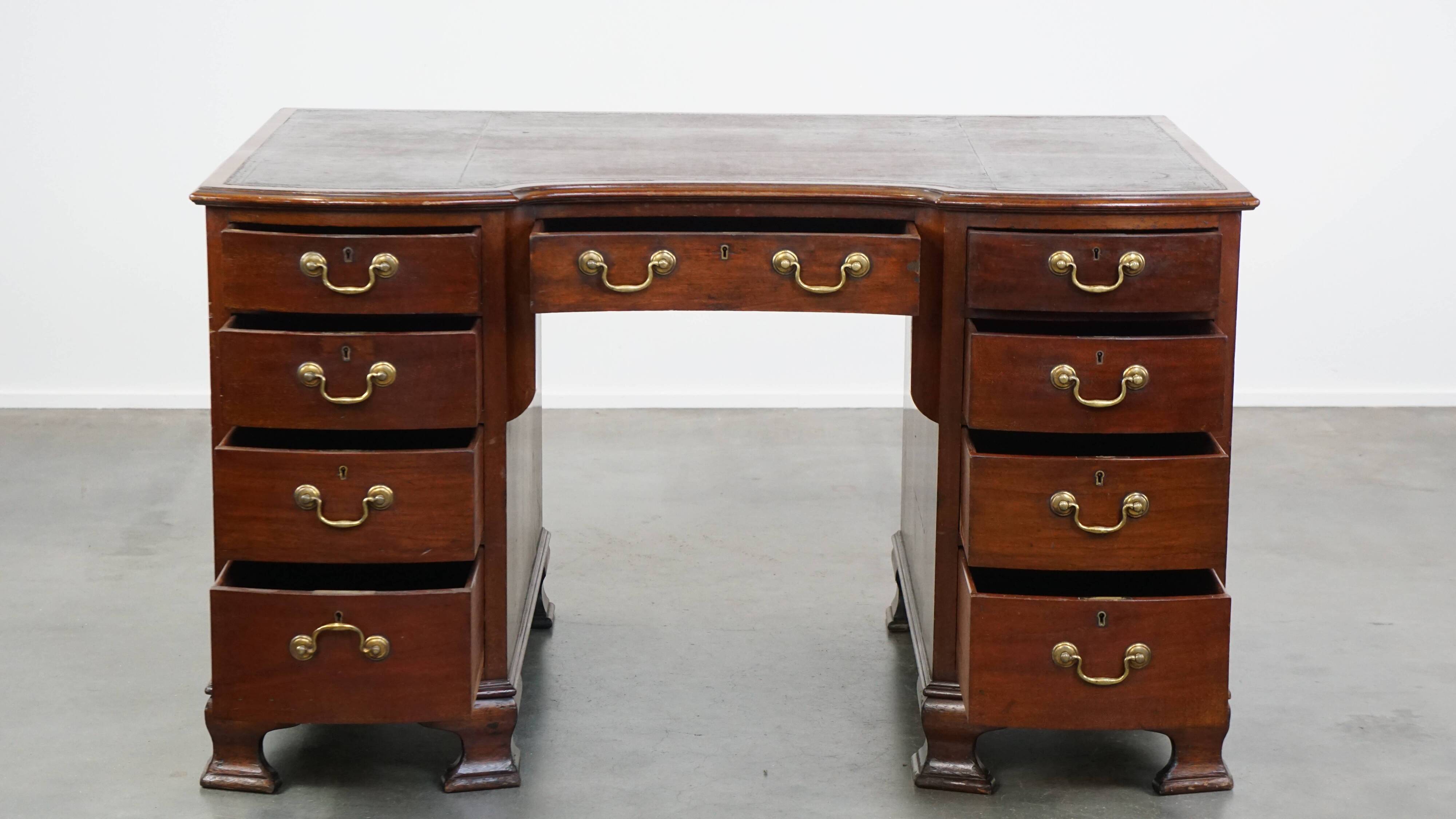 Antique wooden English desk from the late 19th century with a leather top