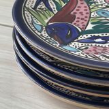 4 colorful flat plates with a fish pattern