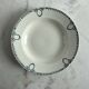 Céranord Saint Amand deep plate with green crown decoration.