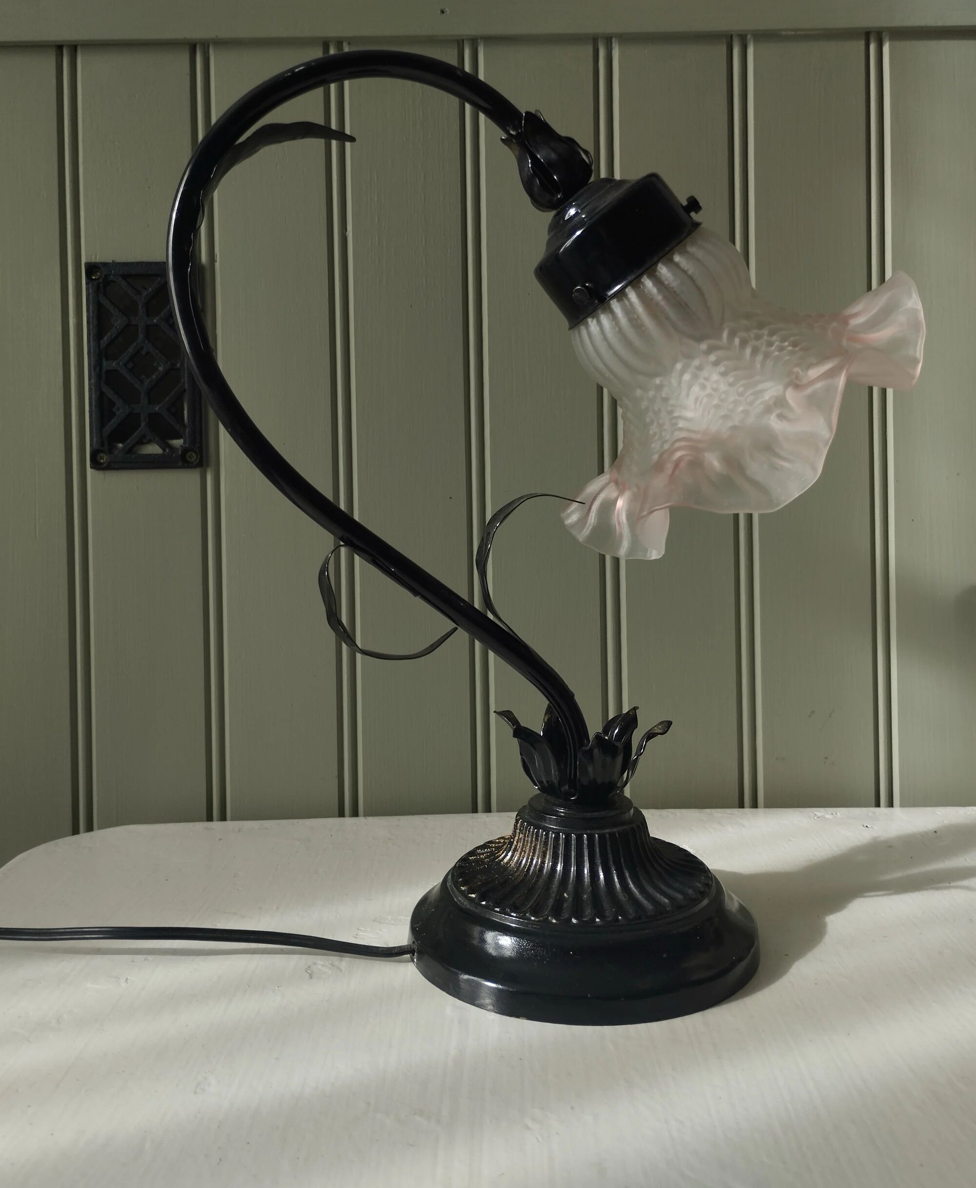 Tulip lamp in patinated black metal with an opaque glass shade.