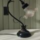 Tulip lamp in patinated black metal with an opaque glass shade.