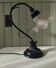 Tulip lamp in patinated black metal with an opaque glass shade.