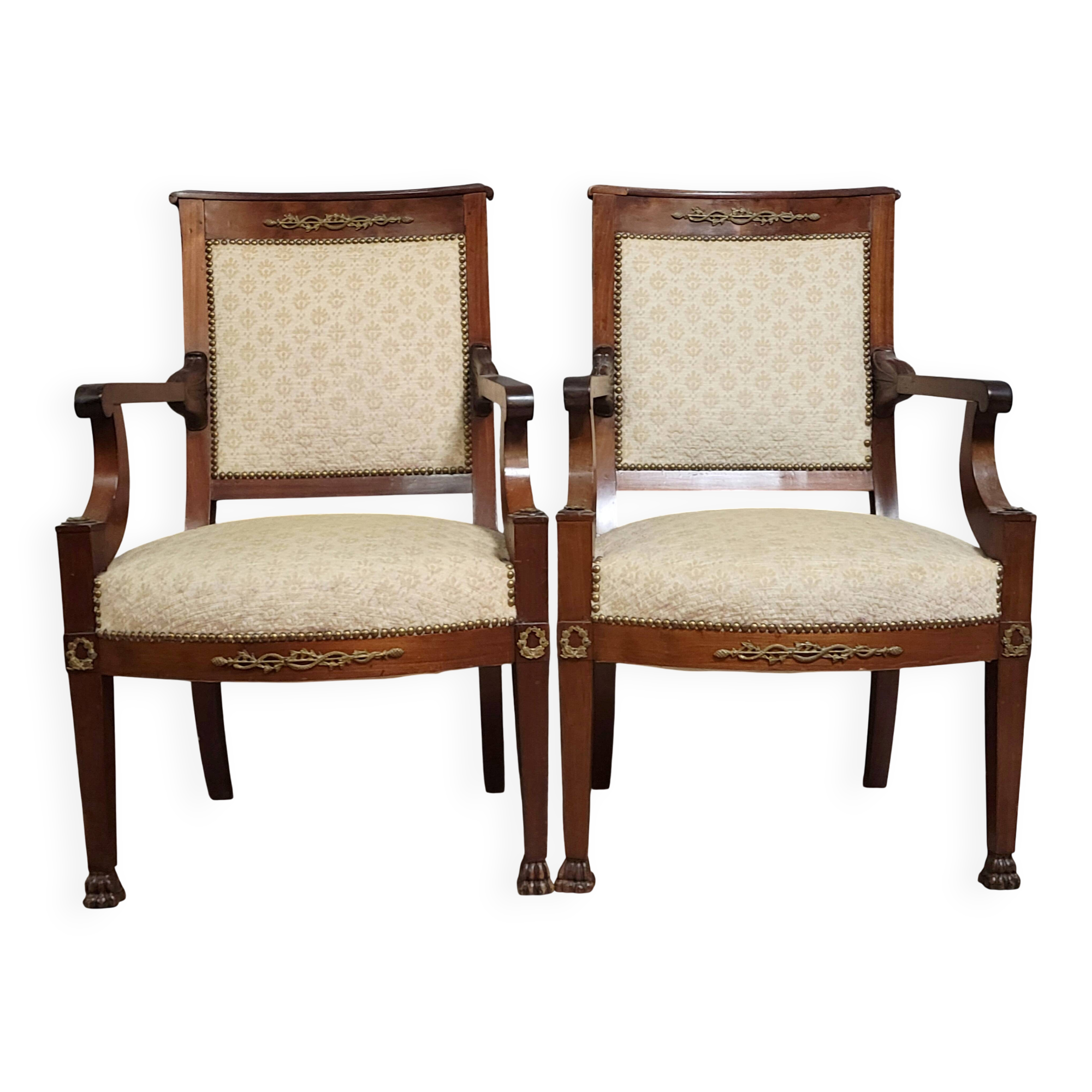 Pair of Empire period armchairs, in mahogany and gilded bronze.
