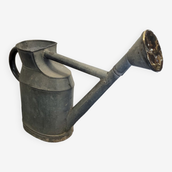 Old zinc watering can with copper apple