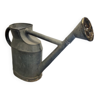 Old zinc watering can with copper apple