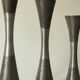 Set of three diabolo-shaped candle holders made of cast steel.
